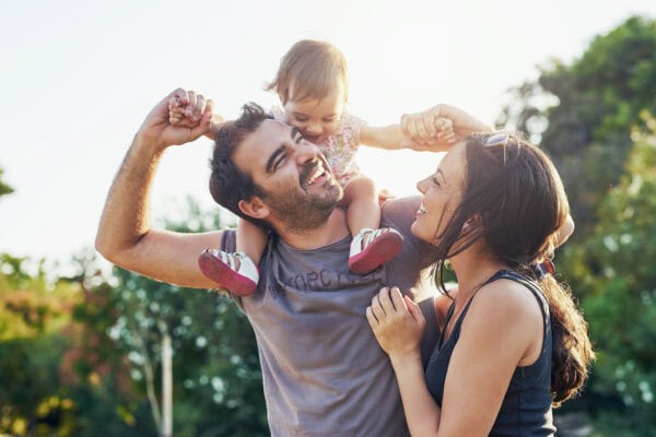 Smiling,Mid,Adult,Couple,Hugging,Each,Other,And,Standing,Near