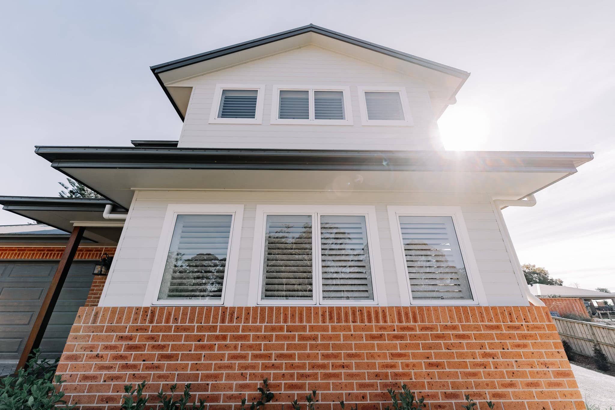 Modern new build family home with white weatherboard and brick facade, great street appeal.