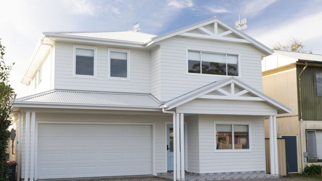 Contemporary white two-storey house with garage and gabled roof fixed price contract