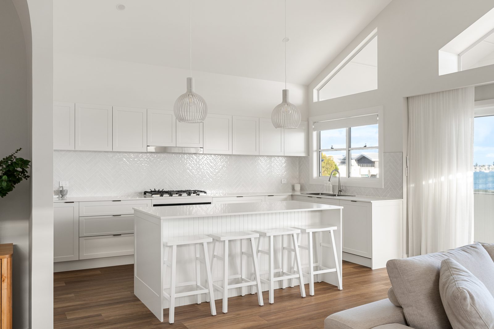 HIA Awards Finalist: Seasgair House, Paul and Bec’s Vision 2 White kitchen with VJ panel island, quartz bench and gloss herringbone splashback