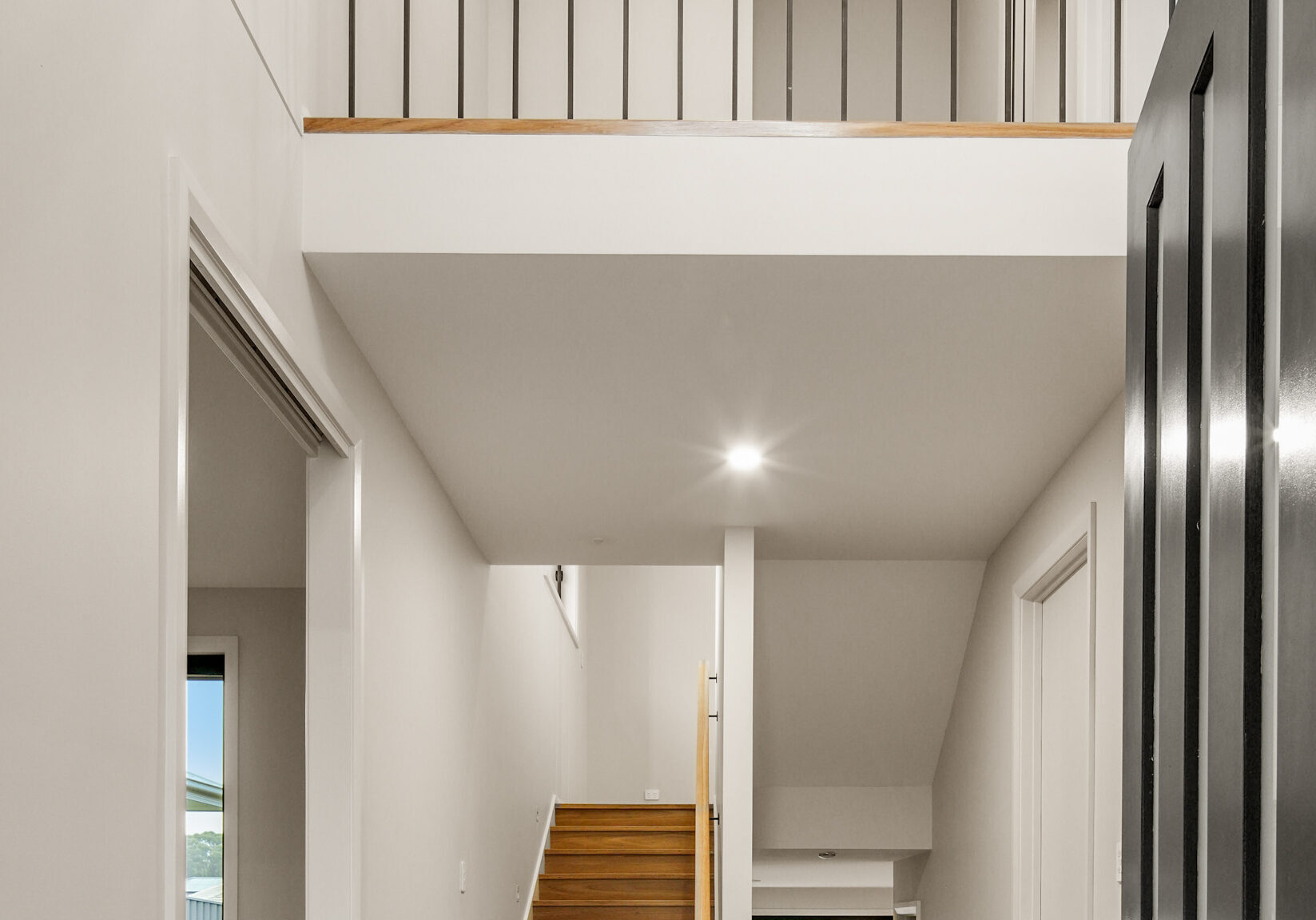 Modern two-storey home interior with staircase and open balcony. showing how Multi-Generational Second-Storey Extensions in Nirimba Fields can be achieved